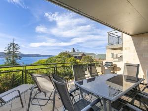 a balcony with a table and chairs and a view of the water at Apartment 26 Pacific Apartments in Lorne