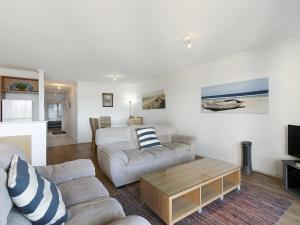 a living room with two couches and a coffee table at Apartment 26 Pacific Apartments in Lorne