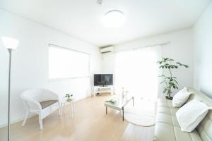 Una televisión o centro de entretenimiento en Yokkaichi Hazunaka Hotel