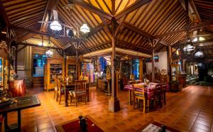 a dining room with tables and chairs in a building at Murni's Houses & Spa in Ubud