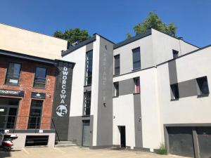 a white building with a sign on it at Apartamenty Dworcowa 45 in Gliwice