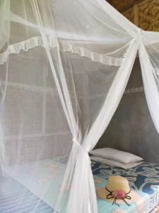 A bed or beds in a room at anik homestay & dormy Batukaras