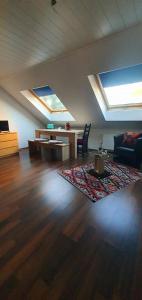 a living room with skylights and a wooden floor at Tulpenoase in Neuendettelsau