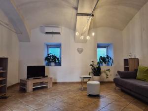 a living room with a couch and a tv at Apartment Pod velbi in Ljubljana