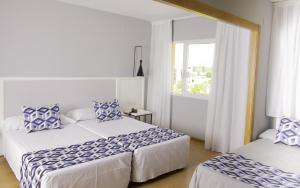 Postel nebo postele na pokoji v ubytování Hotel Beleret