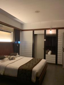 a bedroom with a large bed in a room at Honeybee Resort in Lonavala