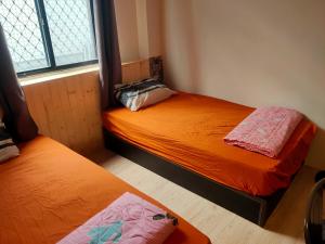 Voodi või voodid majutusasutuse Formosa Backpackers Hostel & Apartment（青年民宿） toas
