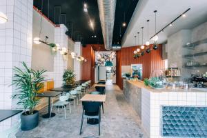 a restaurant with a row of tables and chairs at Gia home in Tel Aviv