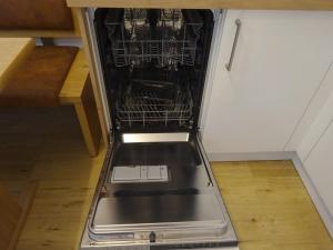 a dishwasher in a kitchen with a metal rack at Garni Sonnleiten in Tirolo