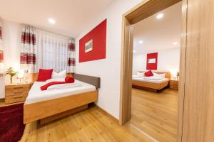 a bedroom with two beds and a mirror at Hotel Restaurant Goldener Hirsch in Donauwörth