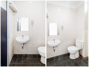 two sinks and a toilet in a bathroom at Hotel Poncowinatan - Tugu in Yogyakarta