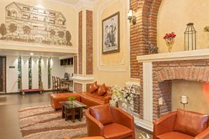 a living room with a couch and a fireplace at Anik Boutique Hotel in Phnom Penh