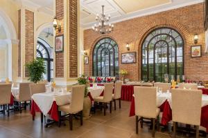 a dining room with tables and chairs in a building at Anik Boutique Hotel in Phnom Penh