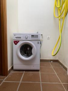 a washing machine in a room with a yellow hose at Villa Denise in Yaiza