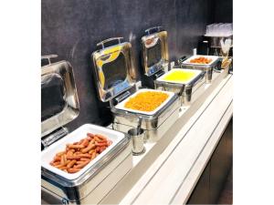 a row of trays of food on a counter at Kuretake Inn Nagoya Hisayaodori in Nagoya