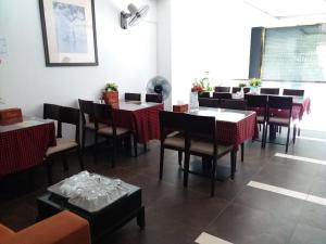 a dining room with tables and chairs in a restaurant at A25 Hotel - 66 Trần Thái Tông in Hanoi