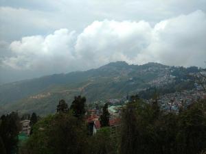 a view of a mountain with a town and a city at Hotel Taktsang Darjeeling in Darjeeling