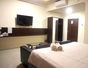 TV a/nebo společenská místnost v ubytování Jember City Hotel