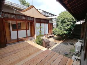 a house with a wooden floor and a patio area at Yuzan Guesthouse in Nara
