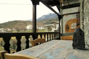 a table on a balcony with a view of a mountain at Romantica suite con vasca idromassaggio in Aosta