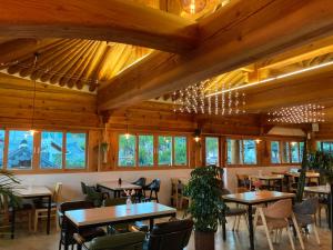 a dining room with tables and chairs and windows at Laon Hanok Gguljam in Jeonju