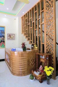 a lobby with a wooden counter and a staircase at Thanh Trang Hotel in Con Dao