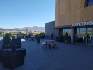 a building with benches and tables outside of it at El Espinar in El Espinar