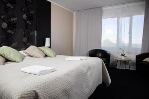 a bedroom with a bed with two towels on it at Hotell Veckefjärden in Örnsköldsvik