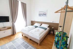 Posteľ alebo postele v izbe v ubytovaní Domus Peregrini Apartmanok