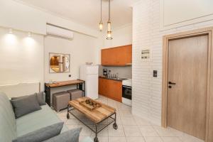 a living room with a couch and a table at Oikion Meteora Home 2 in Kalabaka
