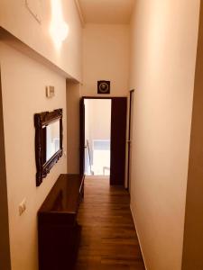 a hallway leading into a room with a mirror and a door at LeonessHouse in Leonessa