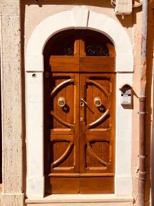 a wooden door in a building with an arch at LeonessHouse in Leonessa