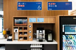 a store with a coffee machine on a counter at Holiday Inn Express Shanghai Tangzhen, an IHG Hotel in Shanghai