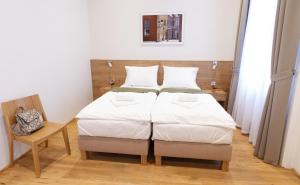 Posteľ alebo postele v izbe v ubytovaní Domus Peregrini Apartmanok