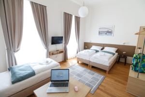 Posteľ alebo postele v izbe v ubytovaní Domus Peregrini Apartmanok