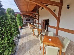 a dining room with wooden tables and chairs at Rákóczi Center in Odorheiu Secuiesc