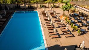 an overhead view of a swimming pool with lounge chairs at Hayat Spa Hotel in Pyatigorsk