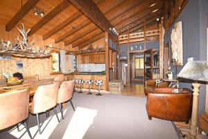 a kitchen and living room with a table and chairs at Rübezahl | Dachgeschoss in Riederalp