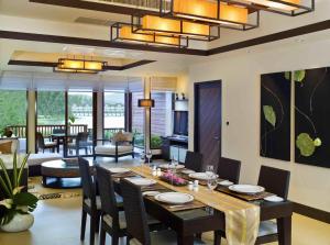 a dining room with a table and chairs at Dusit Thani Laguna Phuket in Bang Tao Beach
