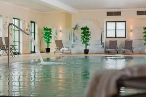 a swimming pool with a fountain in a building at Vital CAMP Bayerbach in Bayerbach