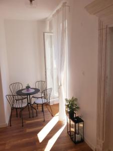 a dining room with a table and chairs and a window at Sorelle apartment in Korčula