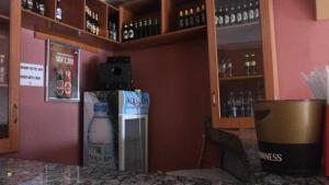 een bar met een fles melk aan de muur bij Highway Motel in Nebbi