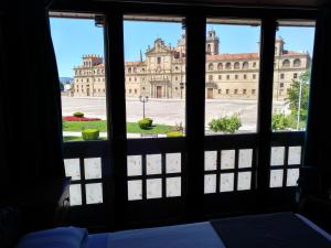 a view of a large building from a window at Hostal Medievo in Monforte de Lemos