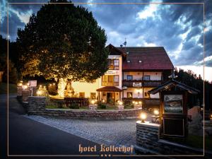 a hotel building with lights in front of it at Hotel Kollerhof in Zelená Lhota