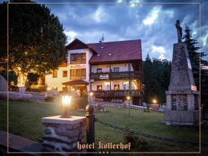 a hotel building with a light in front of it at Hotel Kollerhof in Zelená Lhota