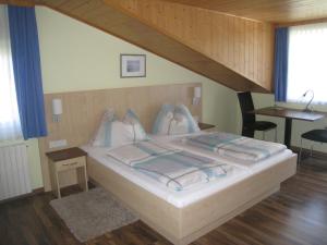 una camera da letto con un letto grande con cuscini sopra di Gasthof Strobl Waldfrieden Garni a Strass im Attergau