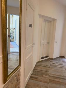 a mirror on a wall next to a hallway at My Friends in Florence