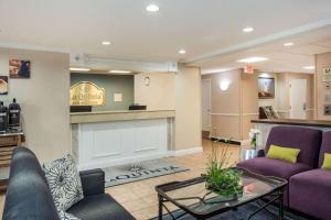 a living room with purple couches and a fireplace at La Quinta by Wyndham Melbourne Viera in Melbourne