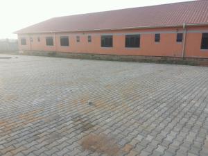 a building with a brick courtyard in front of it at Range Lands Hotel in Moroto