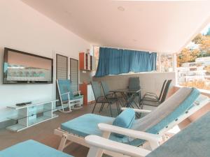 a living room with chairs and a flat screen tv at Comfort Apartment with Sea View in Neum